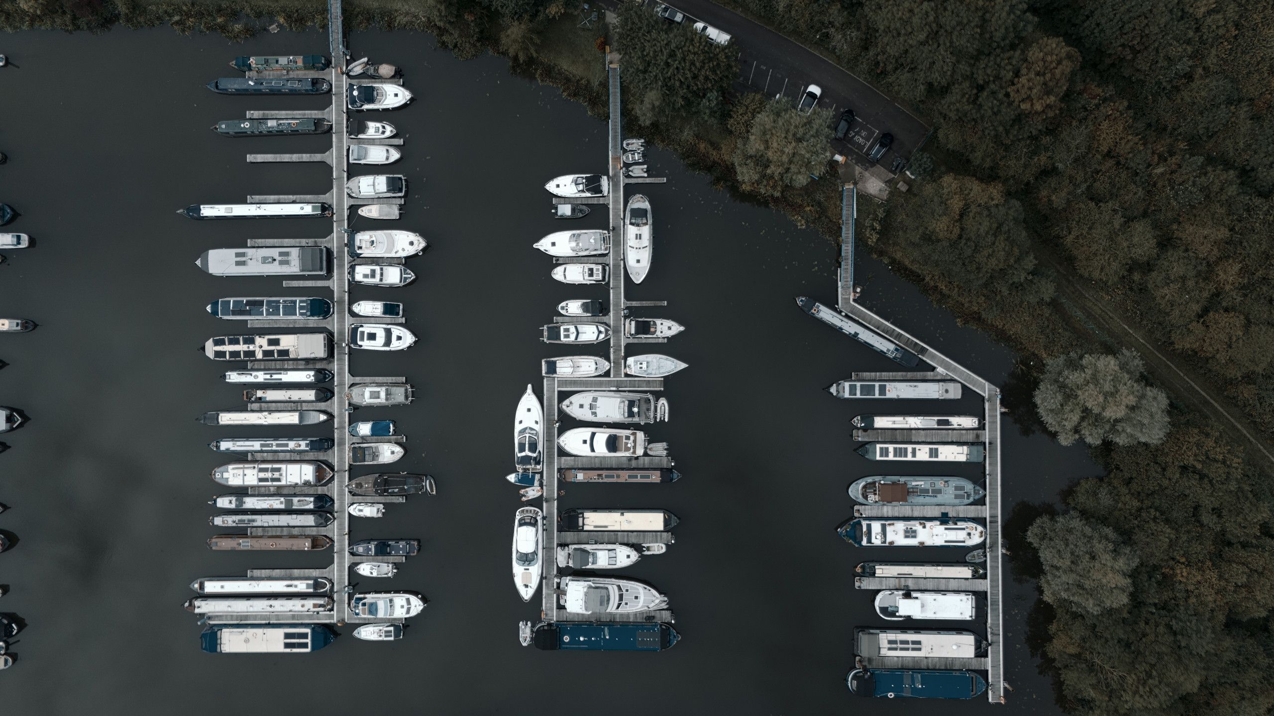 Top-down aerial photograph of boats arranged along marina pontoons